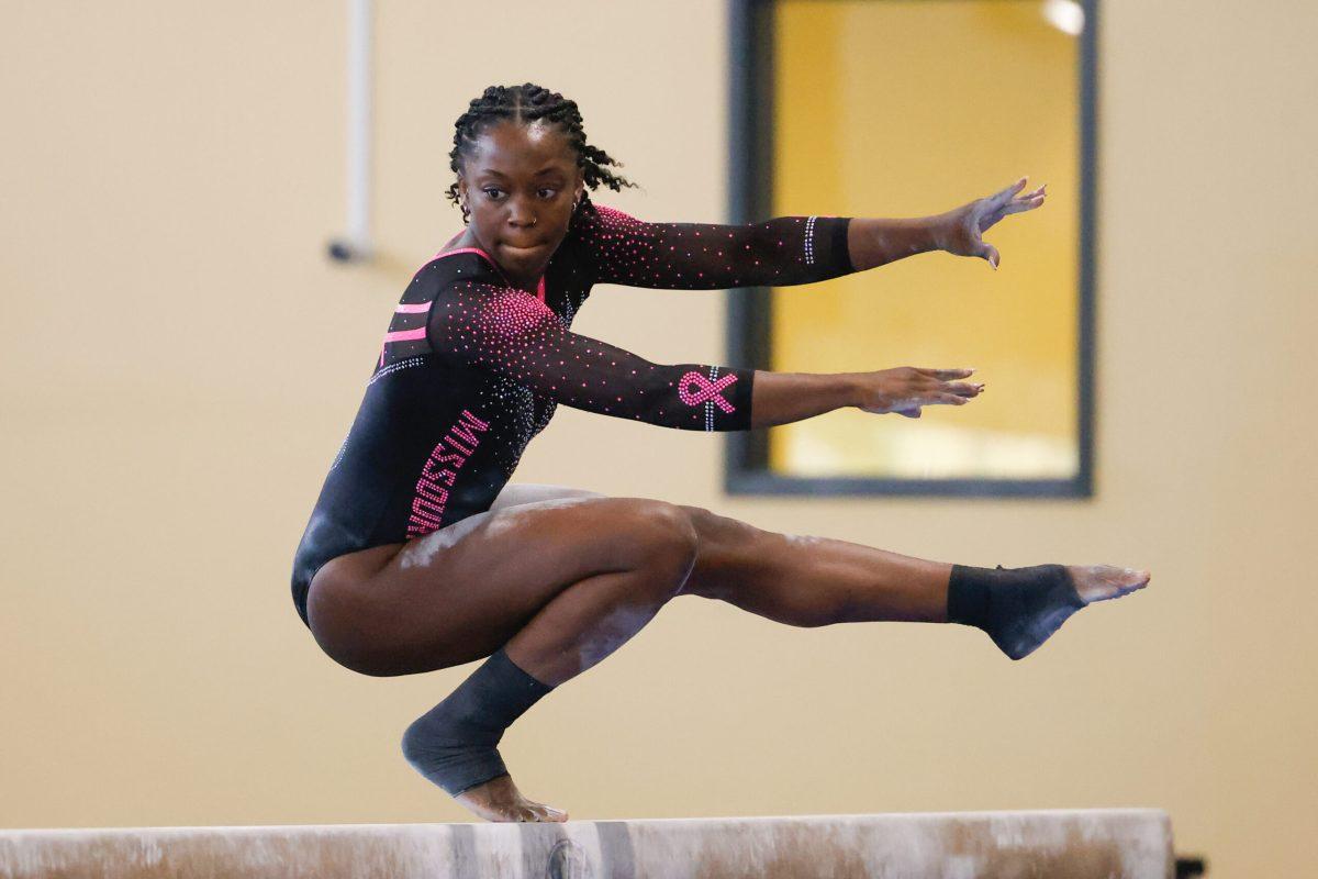 A Missouri gymnast practicing on the beam.