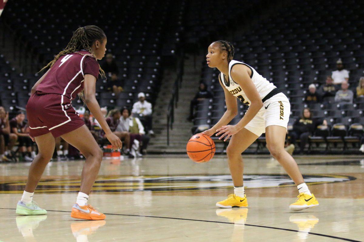 A Missouri basketball player handling the ball.