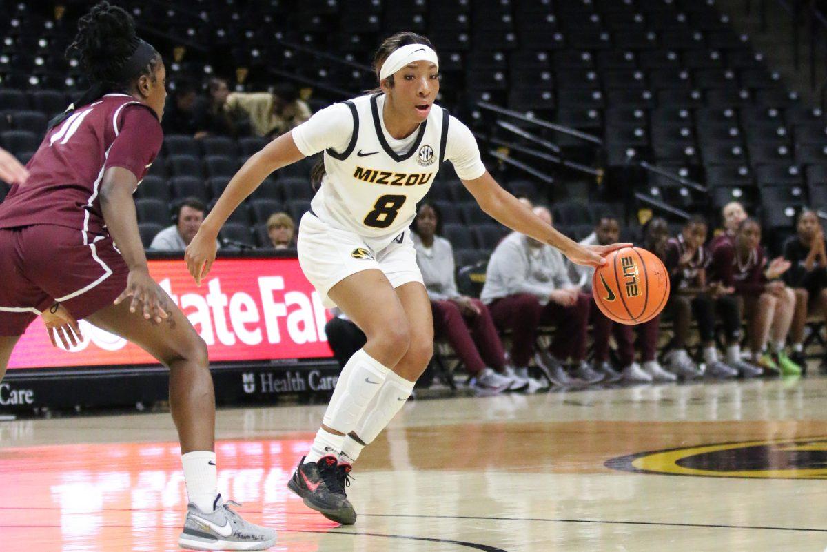 A Missouri basketball player dribbling a ball.