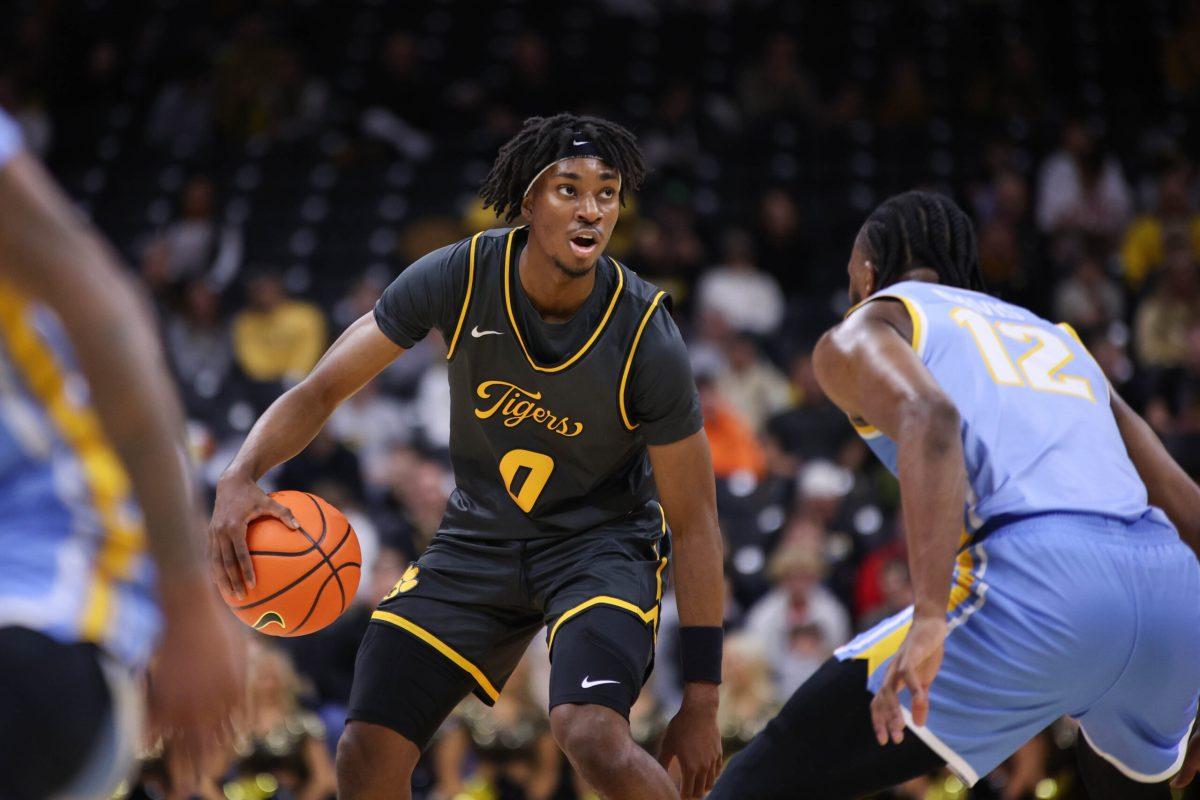 A Missouri basketball player dribbling the ball.