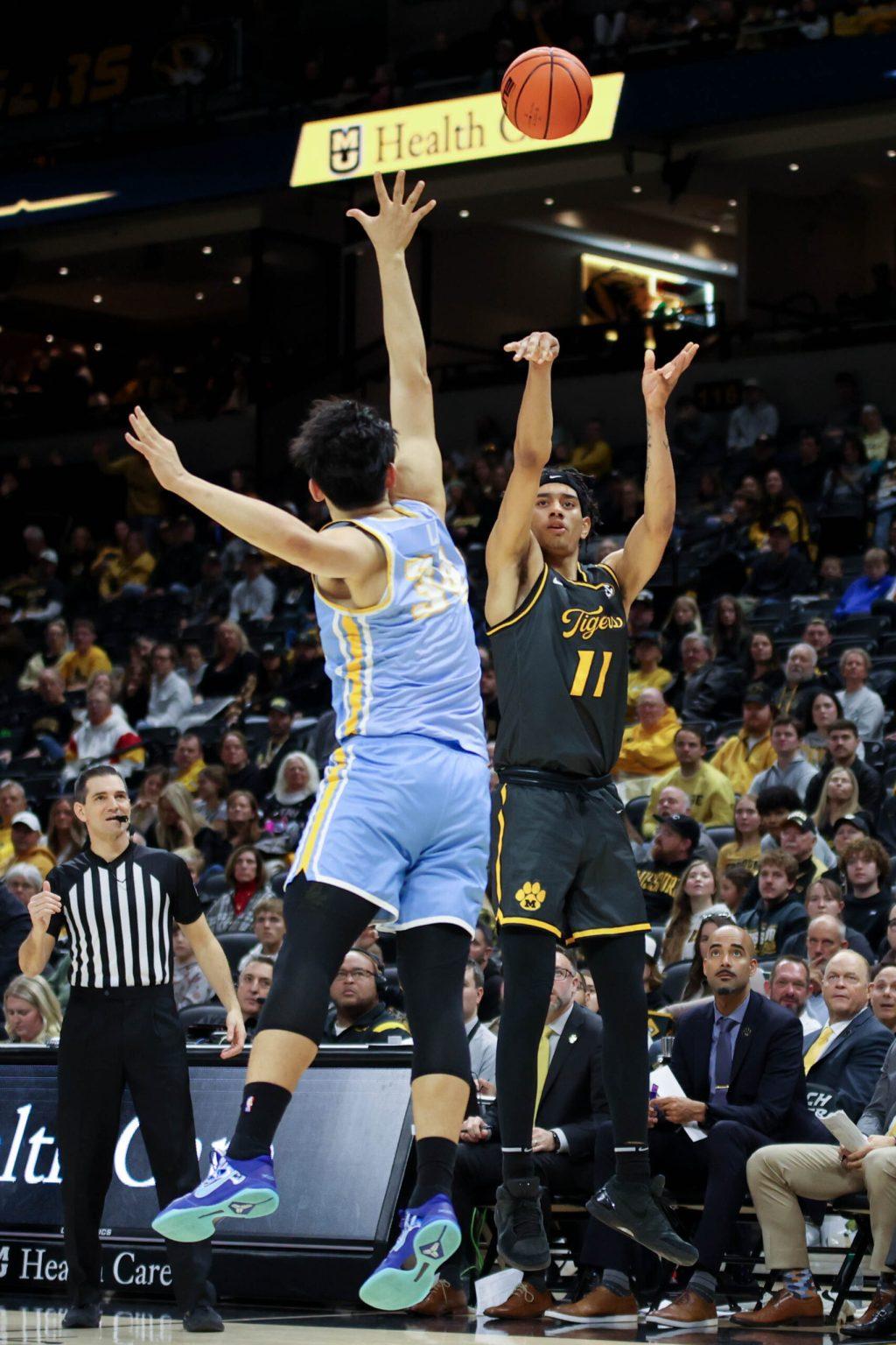 A Missouri basketball player shooting a 3-pointer.