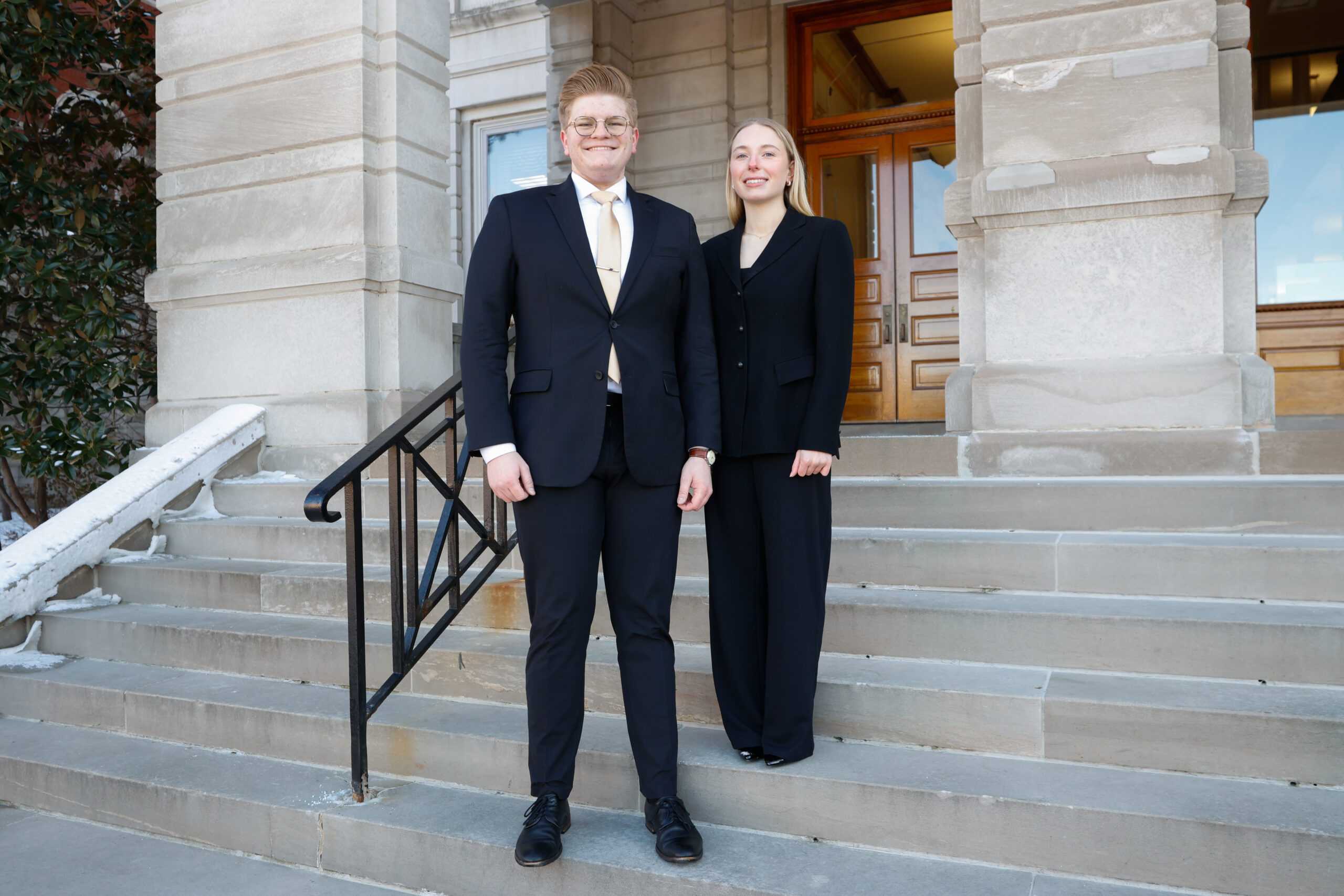 A man and a woman stand together in front of Jesse Hall.