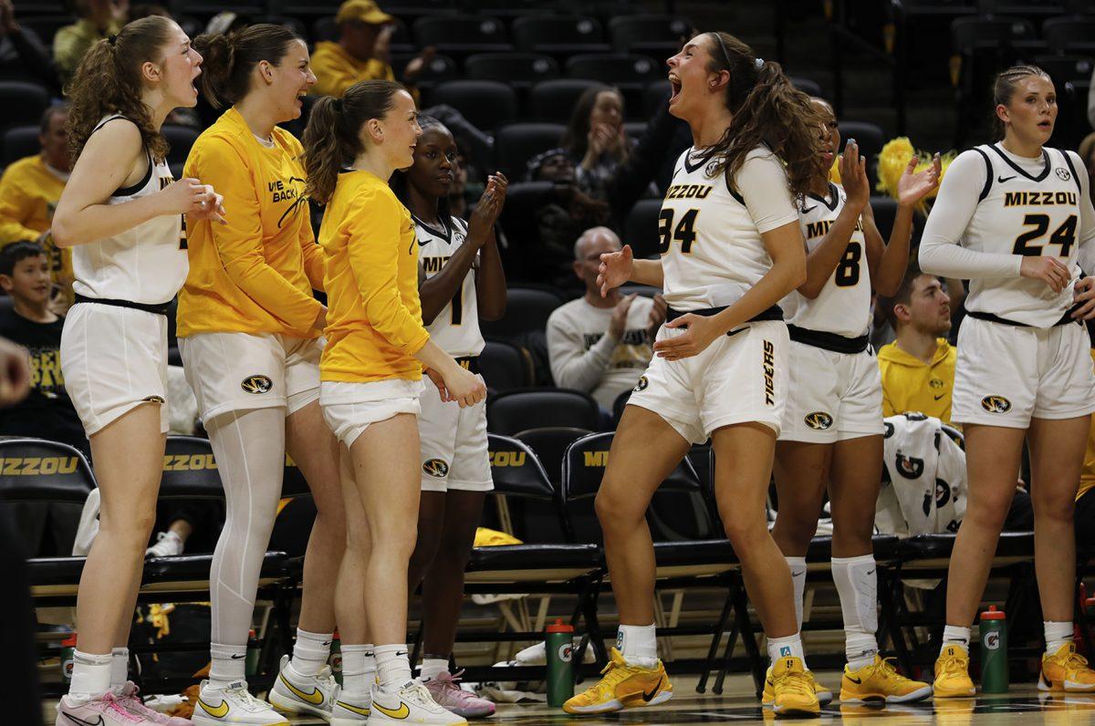 Missouri women’s basketball players cheering from the bench.