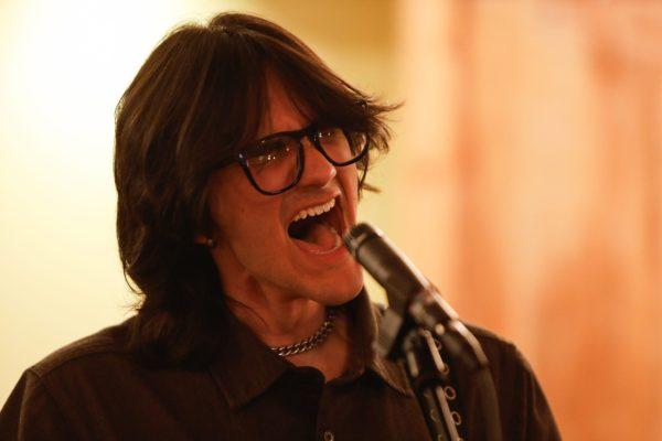 A person sings into a microphone.