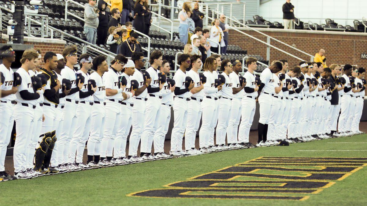 Missouri baseball players line up for the national anthem.