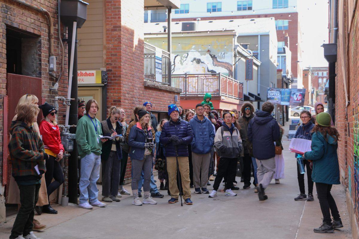 A crowd gathers around an art installation.