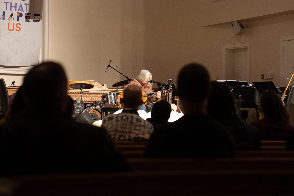 A guitarist performing onstage.