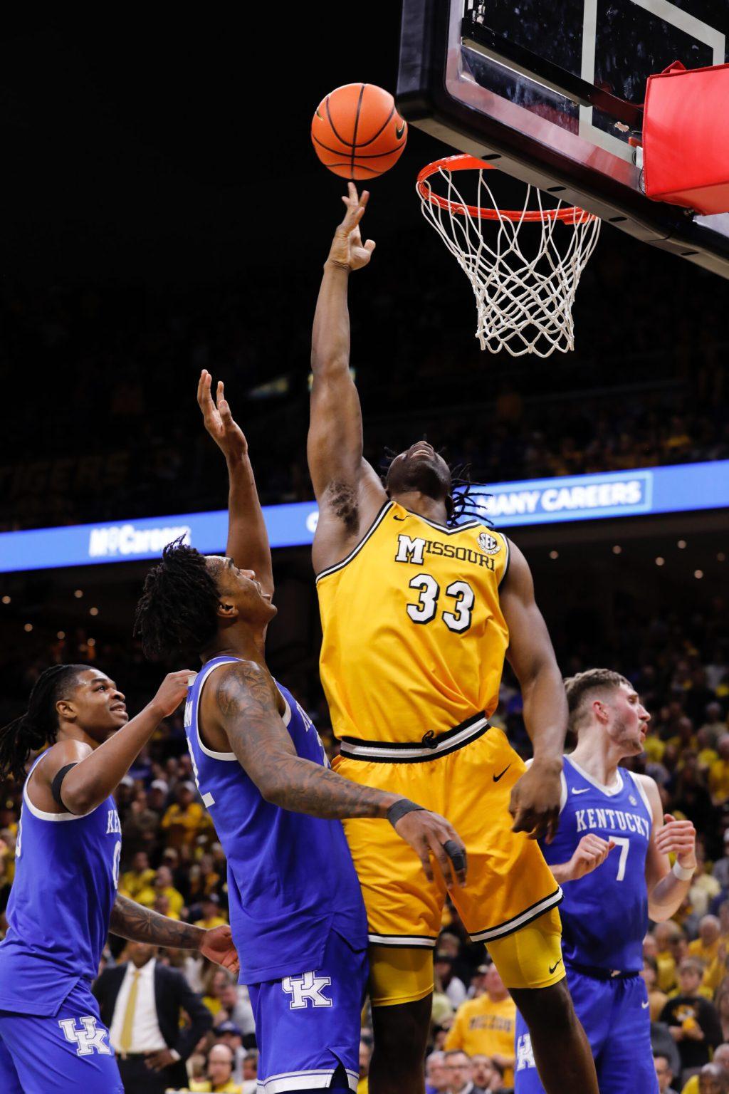 Missouri basketball player jumps to the ball.