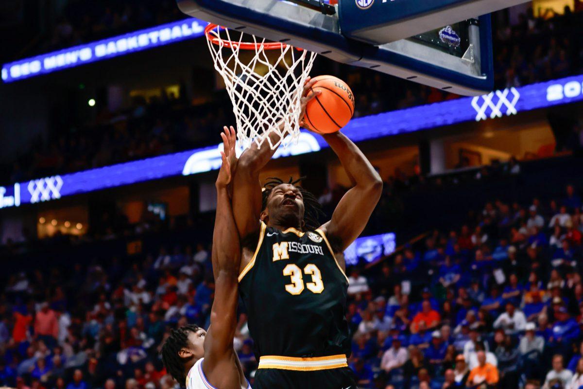 A Missouri basketball player shoots a basketball.