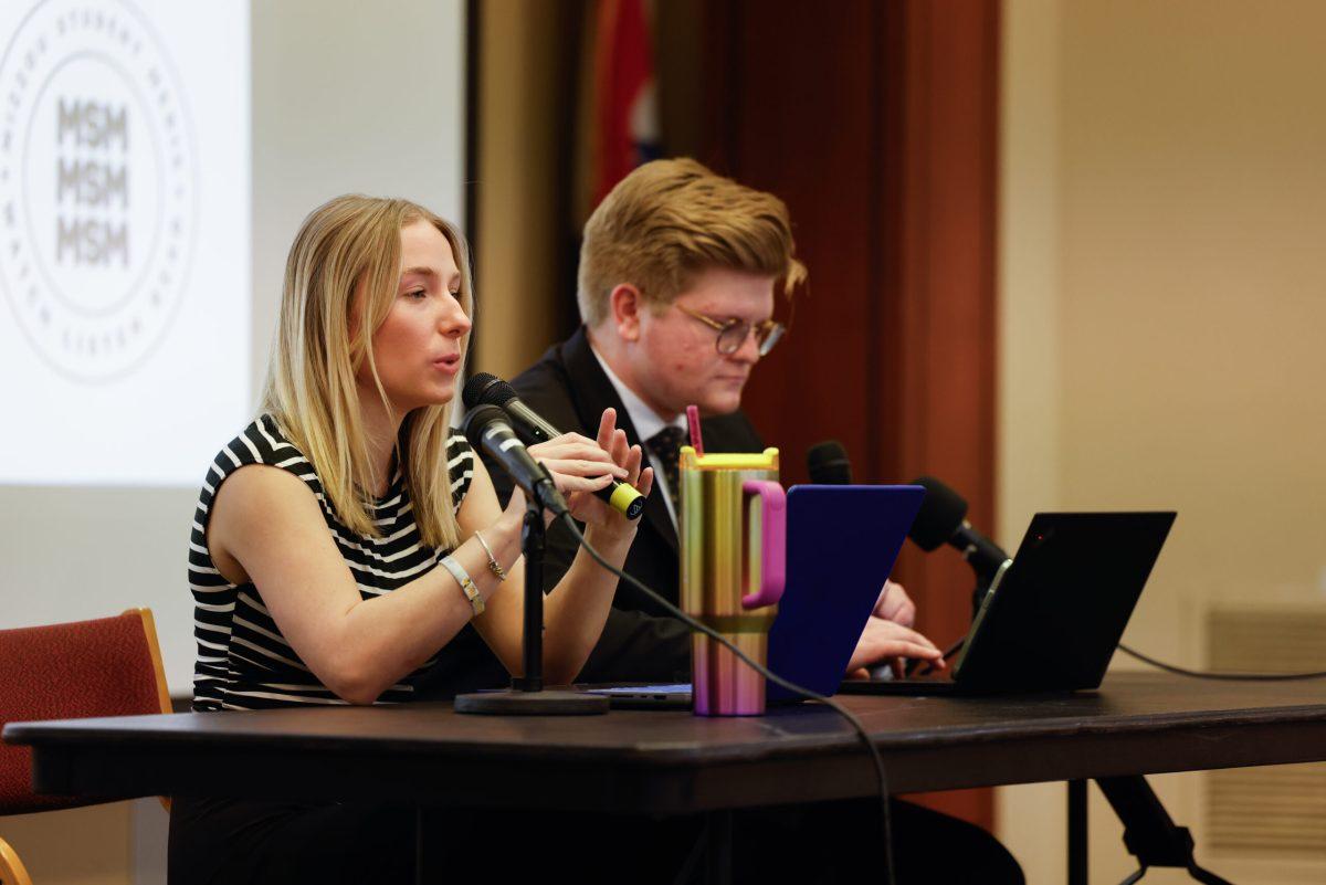 A woman speaks into a microphone.