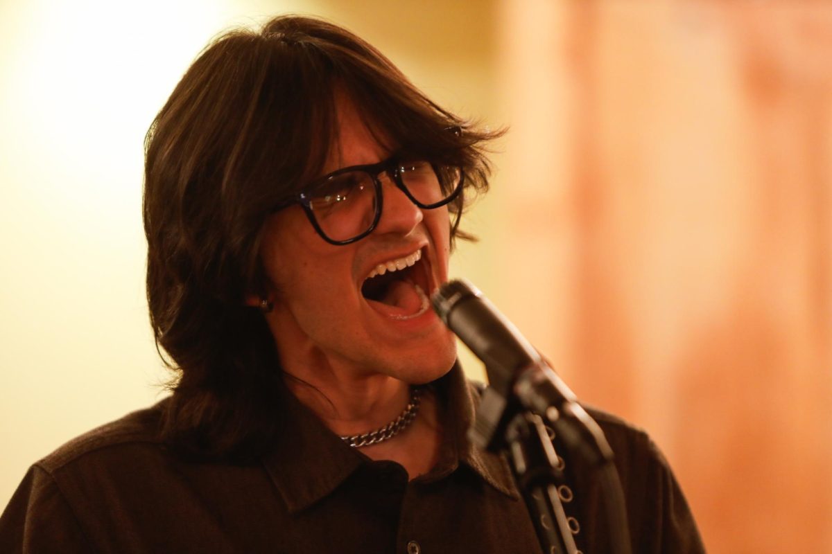Drona multi-instrumentalist Arjuna Raghu sings into a microphone on Sunday, March 2, 2025, at the Missouri Theatre in Columbia, Mo. “It's the ultimate form of artistic validation to have people listen and hum along and dance to the music you make,” Raghu said.