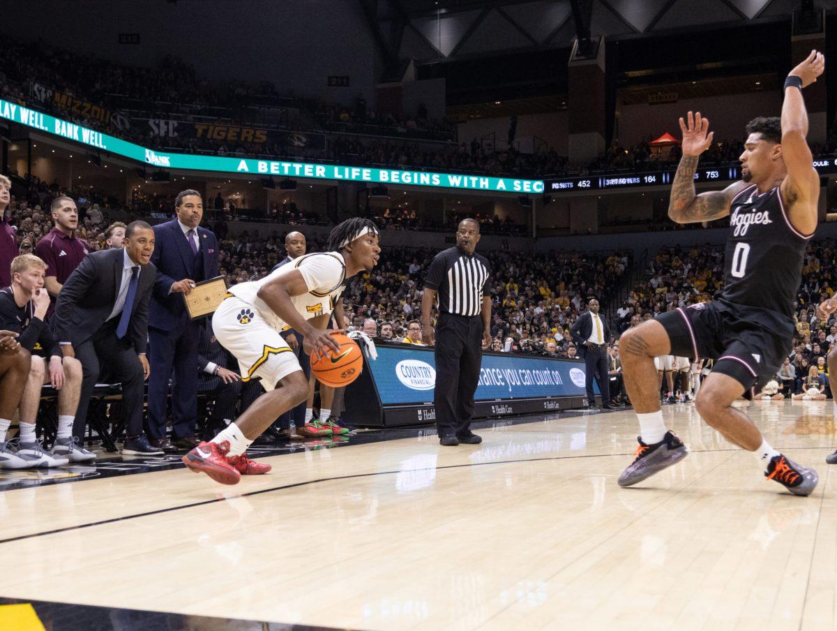 A Missouri basketball shooting guard creates room against a Texas A&M guard.