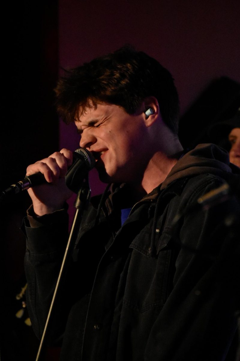 Pink Houses singer Charlie Bickel belts into the microphone during their show on Saturday, April 26, 2025, at Cafe Berlin in Columbia, Mo. Their new EP, Roadrunner, contains six new songs and is available for purchase at their shows.