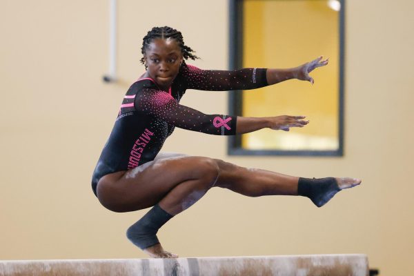 A Missouri gymnast practices performing on the beam.
