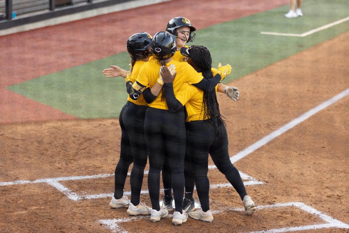 Missouri freshman Madison Uptegrove and her teammates have a group hug at home plate after she hit a three-run home run during the Black vs. Gold Game on Thursday, Oct. 24, 2024, at the Mizzou Softball Stadium in Columbia, Mo. Uptegrove, who is a Columbia native, holds the top spot in Father Tolton record book for doubles, triples and total bases.