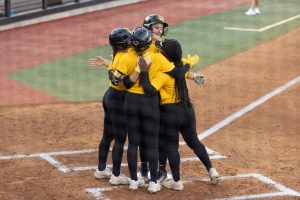 Missouri freshman Madison Uptegrove and her teammates have a group hug at home plate after she hit a three-run home run during the Black vs. Gold Game on Thursday, Oct. 24, 2024, at the Mizzou Softball Stadium in Columbia, Mo. Uptegrove, who is a Columbia native, holds the top spot in Father Tolton record book for doubles, triples and total bases.