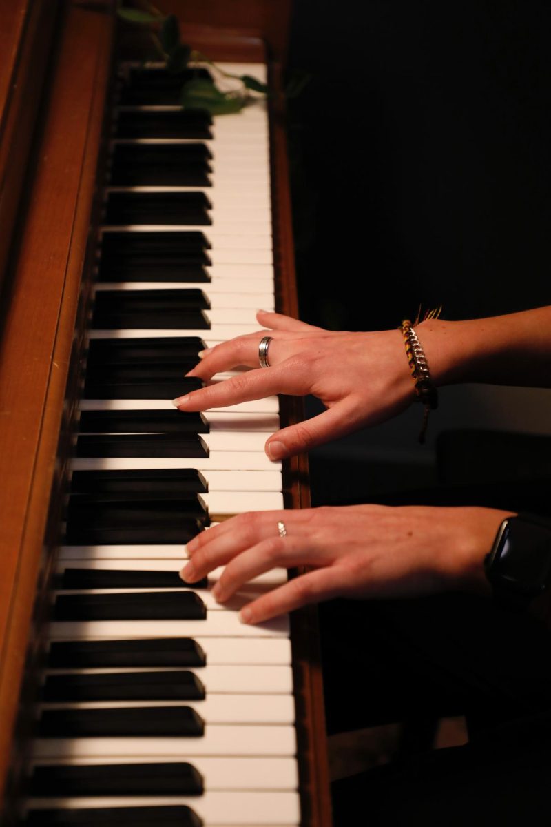 Kiley Grimes, Mizzou student and owner of Soundcheck, plays the piano at her studio. This studio comes fully equipped with drums, keyboards, a piano, and more.