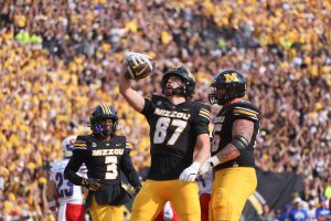 Missouri tight end Brett Norfleet holds his trophy high after a successful play while ​​Kevin Coleman Jr. and Dominic Giudice look on during Missouri’s game versus Kansas on Saturday, Sept. 6, 2025, at Faurot Field in Columbia, Mo. Norfleet finished the game with two touchdowns and 76 receiving yards against Kansas.
