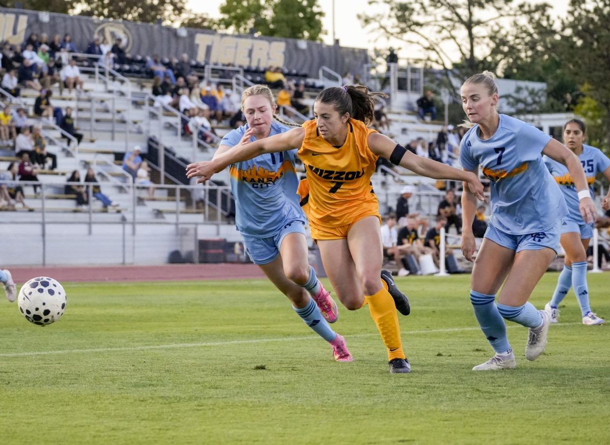 Missouri forward Bella Carrillo fights off defenders Olyvia Pugh and Madelyn Muhr in the first half of a match against Kansas City on Sunday, Sept. 7, 2025 at Walton Stadium in Columbia, Mo. Missouri will take on Texas on Friday, Sept. 12, in Columbia.