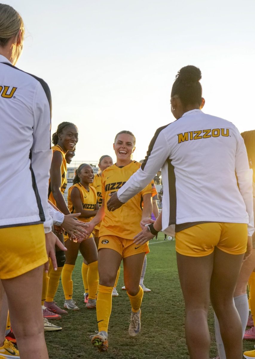 Missouri midfielder Keegan Good smiles as she runs through a high-five tunnel before the Tigers’ match against Kansas City on Sunday, Sept. 7, 2025 at Walton Stadium in Columbia, Mo. Good finished the game with four shots and one shot on goal.