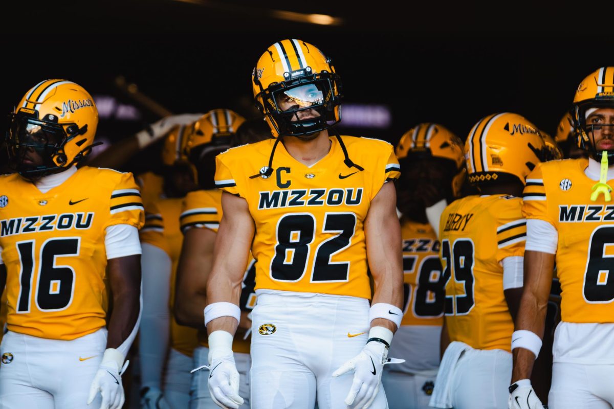 A man in a football uniform looks outward