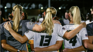 Missouri women’s soccer players Morgan Meador, Callaway Combs, and Ava Vetter hold each other in celebration after their win over Texas on Sept. 12, 2025, at Walton Stadium in Columbia, Mo.