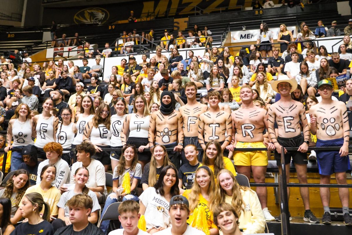 A group of Missouri students stand at the front of the volleyball court with shirts reading “Forest Fire” on Tuesday, Sept. 9th, 2025, at Hearnes Arena in Columbia, Mo. Before the start of the game the letters on their bodies were intact, but towards the end of the match, their excitement and sweat had faded the letters.
