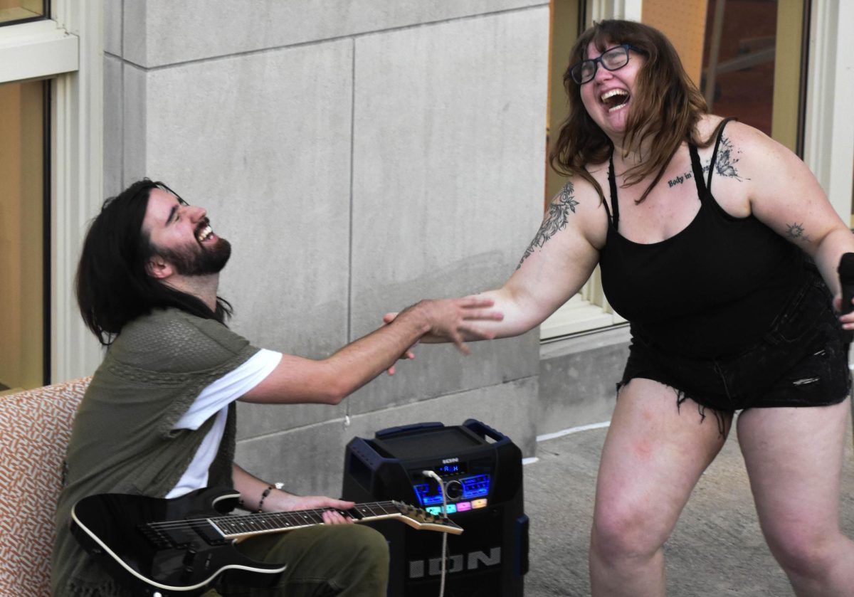 Mizzou Poetry Club president Joe Hess and officer Ellie Dugdale laugh after performing during the group’s first open mic poetry event on Wednesday Sept. 10 in front of Reynolds hall in Columbia, Mo. The night included more than poetry readings, with singing, storytelling and even comedy acts. The club meets at least once a month. 