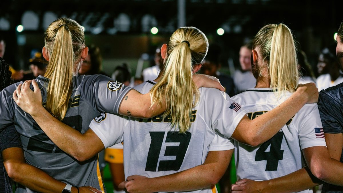 Missouri women’s soccer players Morgan Meador, Callaway Combs, and Ava Vetter hold each other in celebration after their win over Texas on Sept. 12, 2025, at Walton Stadium in Columbia, Mo.
