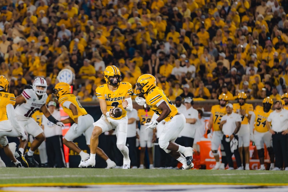 Missouri quarterback Beau Pribula passes the ball to running back Ahmad Hardy during the game against Massachusetts on Saturday, Sept. 27, at Faurot Field in Columbia, Mo. Hardy scored three touchdowns for the Tigers during the Saturday night game.