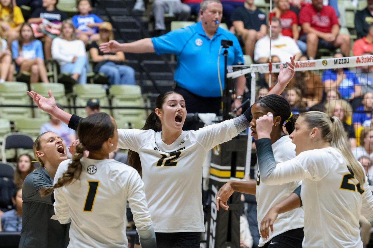 Outside hitter Janet deMarrais, stretches her arms wide to her teammates celebrating a long rally during Missouri’s game against Arkansas on Friday, Oct. 3 at the Hearnes Center in Columbia, Mo. deMarrais had a total of 11 kills and scored 14.5 points in the match.