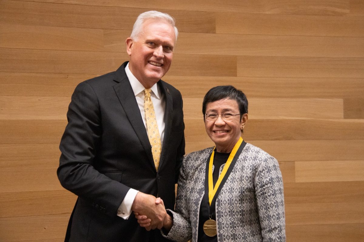 Missouri Honor Medal recipient Maria Ressa and Missouri Dean of Journalism David Kurpius shake hands after Ressa is presented with her award on Tuesday, Sept. 30, at the State Historical Society of Missouri in Columbia, Mo. Ressa was recognized for her contributions to and founding of Rappler, an investigative news site in the Philippines that has faced multiple shut down attempts by the Philippine government.