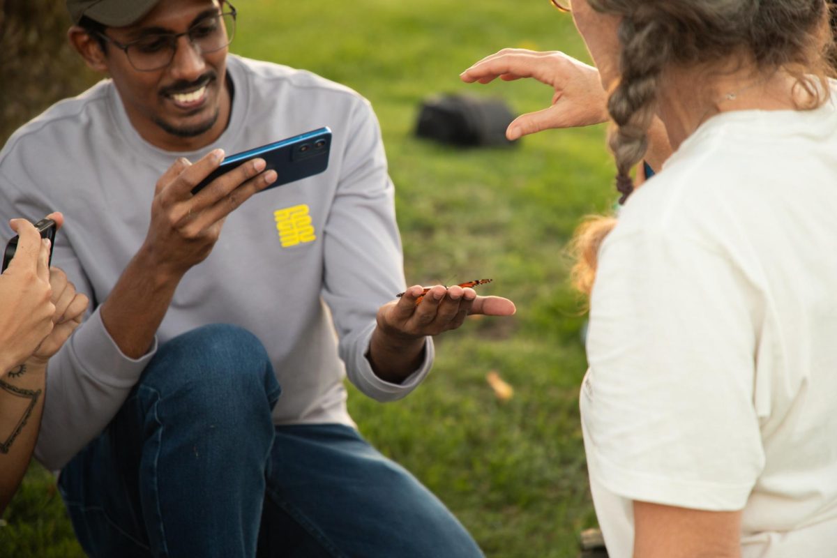 Missouri Ph.D student Isuru Lakshika Weligama Arachchige carefully holds a newly tagged monarch butterfly on Thursday, September, 25, during the Monarch Migrations event at A.L. Gustin Golf Course. Monarch butterflies are tagged to track their migration south during the winter months. 