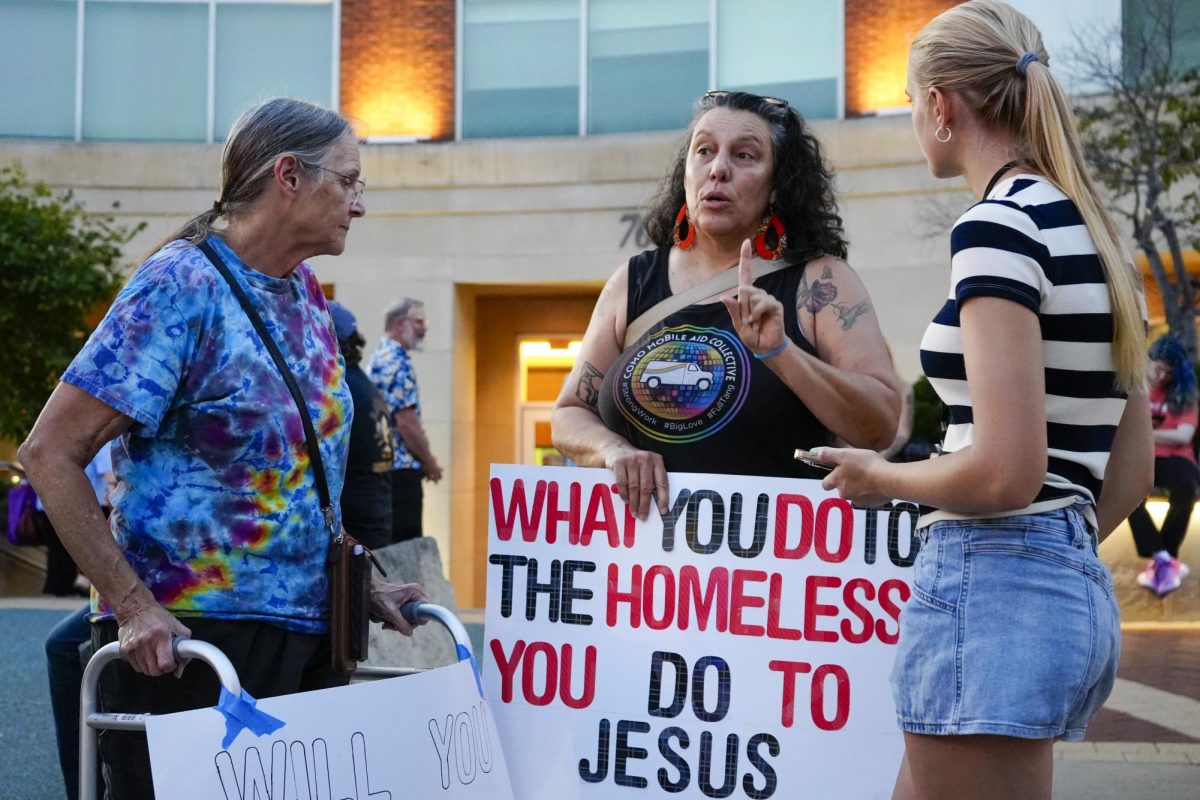 Margaret McConnell, left, listens as Katherine Armbrust is interviewed by Maneater reporter Hannah Halterman at a protest against a proposed anti-panhandling ordinance on Monday, Oct. 6 at Columbia City Hall in Columbia, Mo. Armbrust was holding a sign that read “What you do to the homeless you do to Jesus”. 