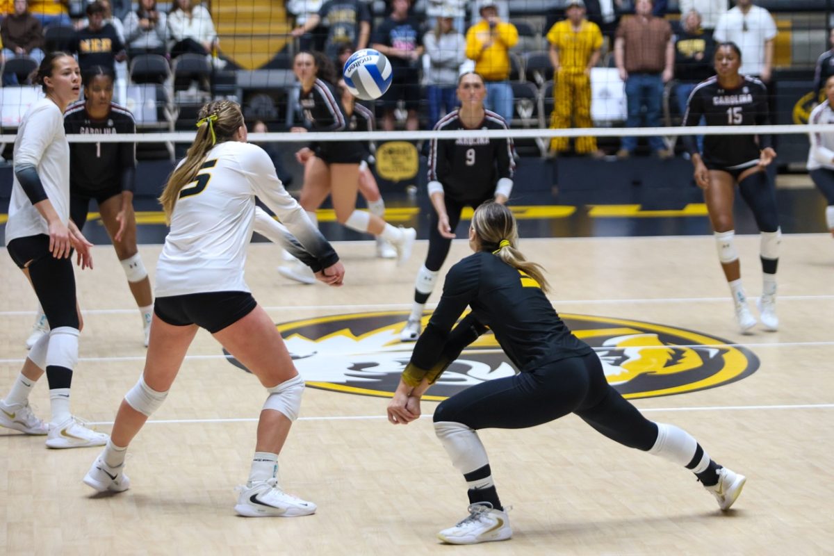 Outsider hitter Paige Felder and libero Maya Sands reach their arms forward for the ball during a game against South Carolina on Friday, Oct. 24 at Hearnes Center in Columbia, Mo. Sands recorded a new career high as she helped lead the Tigers to victory with 32 total digs. 