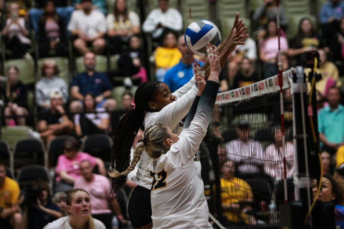 Missouri middle blocker Tyrah Ariail and setter Marina Crownover reach up to
the net to block a hit from Ole Miss on Friday, Oct. 17th at the Hearnes Center in Columbia, Mo. Crownover logged 33 assists against the Rebels.