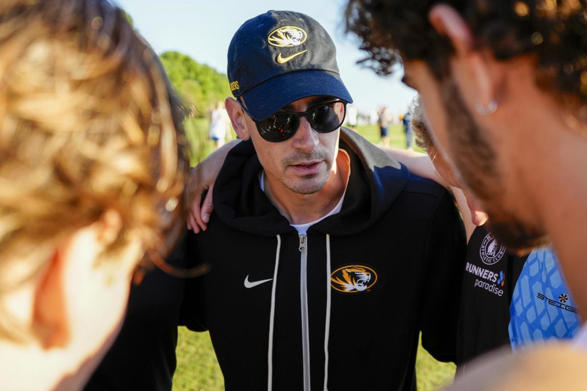 Missouri assistant coach Kyle Levermore huddles with the men’s team before the first race of the morning at the Gans Creek Classic, held on Friday, Sept. 26 at the Gans Creek Course in Columbia, Mo. The Missouri men’s team placed 12th among 31 teams. 