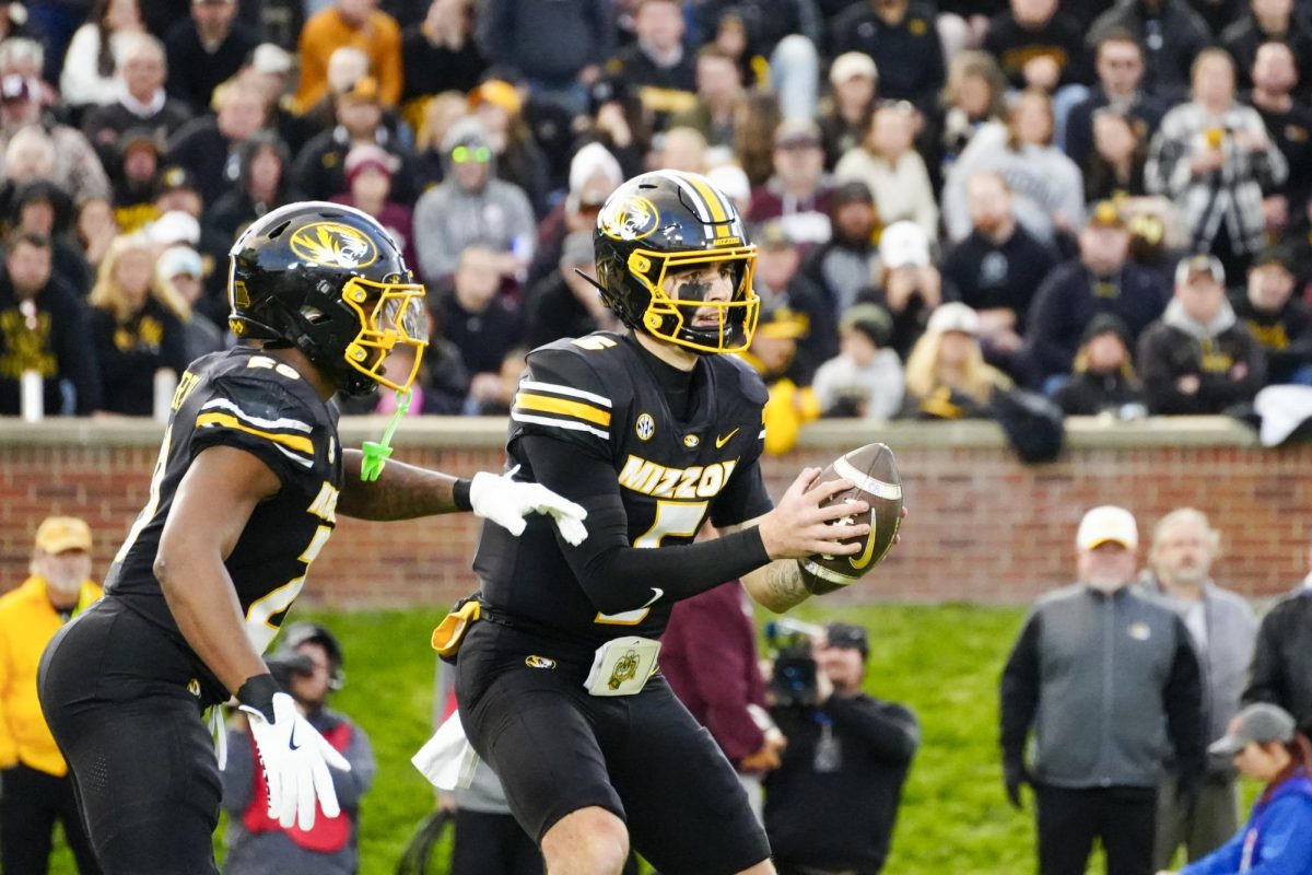 Missouri quarterback Matt Zollers hands the ball off to running back Jamal Roberts in the third quarter of the game against Texas A&M on Saturday, Nov. 8 at Faurot Field in Columbia, Mo. Roberts led the team in rushing yards with 110 in Missouri’s 38-17 loss to Texas A&M. 