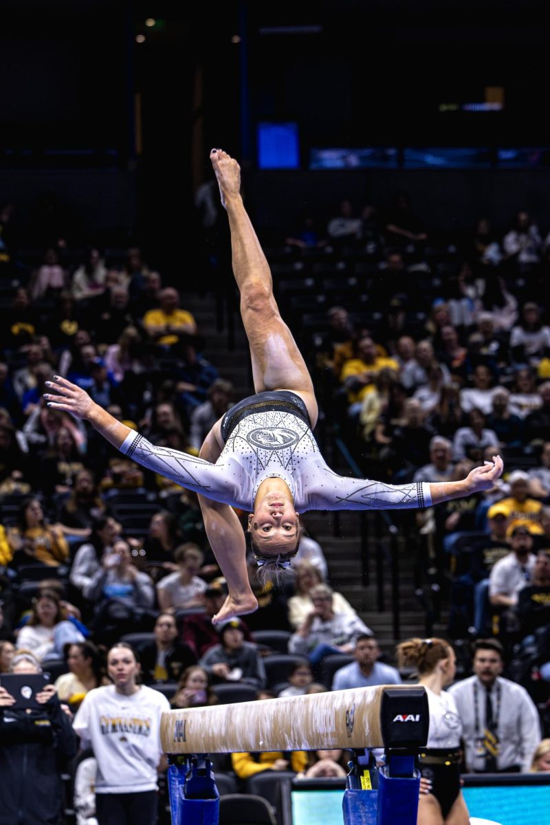 Kaia Tanskanen spots the beam during a back layout step-out on Friday, Feb. 20 at Mizzou Arena in Columbia, Mo. Tanskanen scored a 9.775 on the balance beam. 