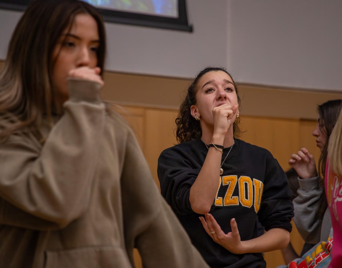 Mizzou Forte’s vice president, Bella Chimino, holds her hand in front of her mouth mimicking a microphone while practicing for the International Championship of Collegiate A Cappella Semifinals on Sunday, March 1, at Sinquefield Music Center in Columbia, Mo. The group will travel to Indianapolis, In, March 14 for the competition. 