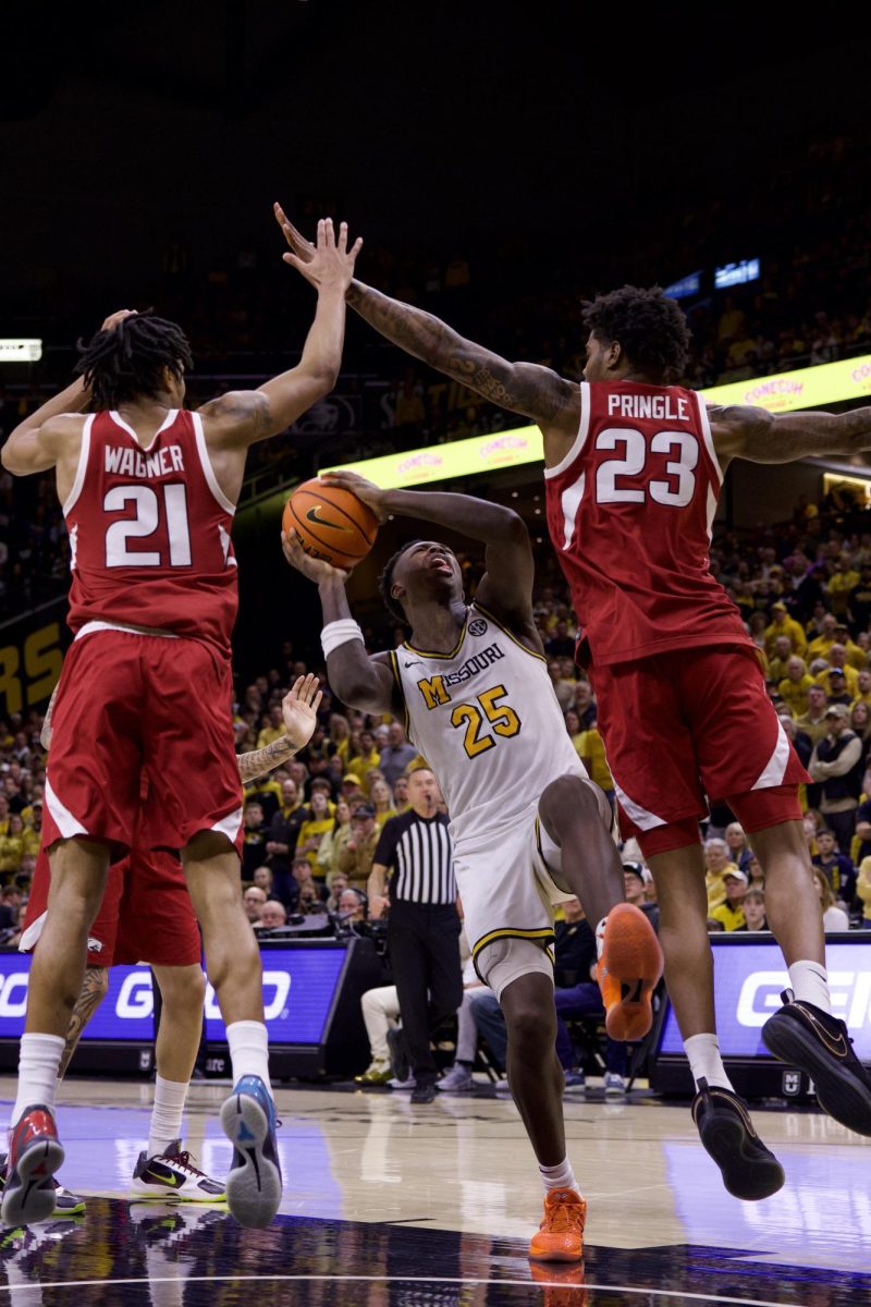 Missouri forward Mark Mitchell goes to make a basket as two Arkansas players defend him on Saturday, March 7 at Mizzou Arena in Columbia, Mo. Mitchell scored a total of 32 points during the game.