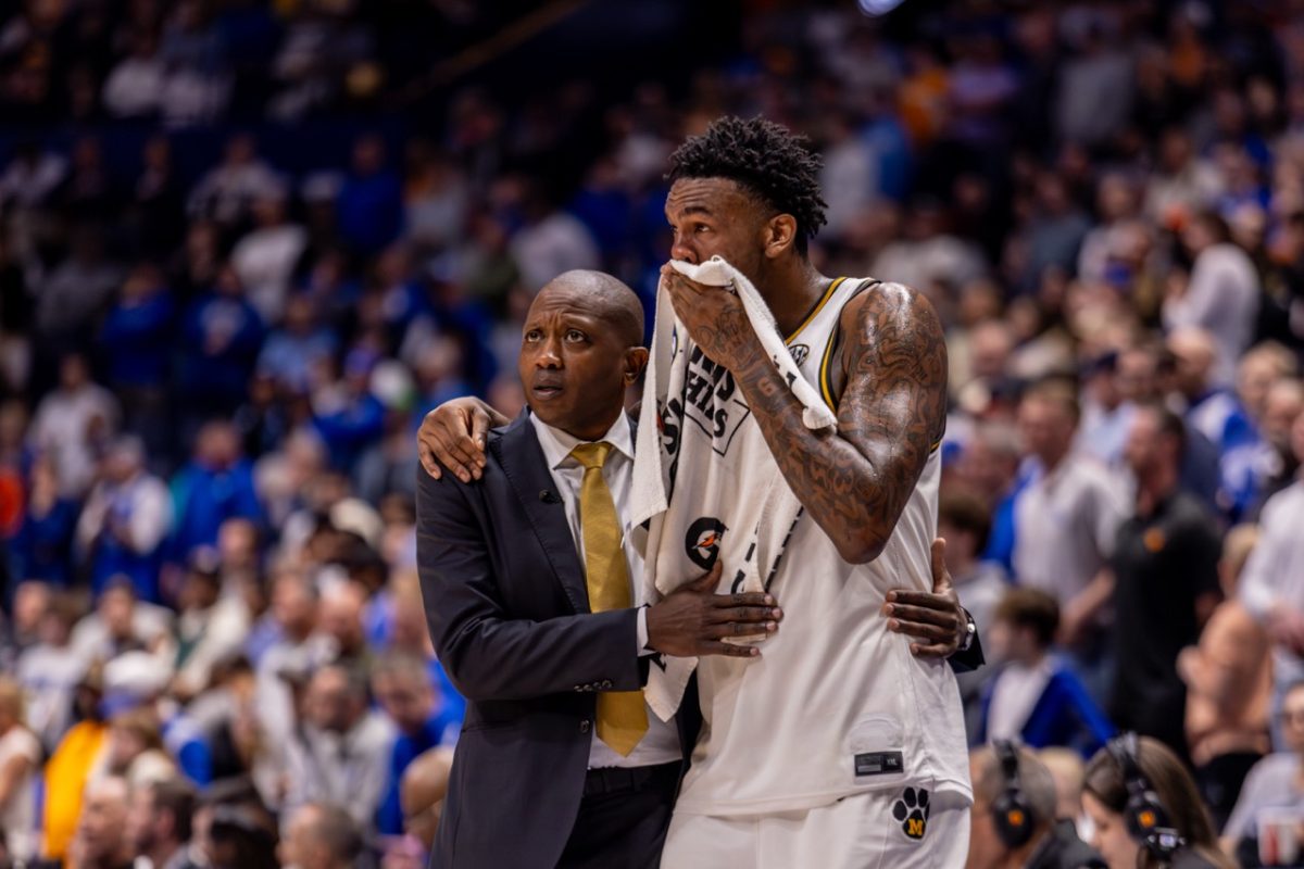 Missouri center Shawn Phillips Jr. and head coach Dennis Gates hug while watching a game against Kentucky on Thursday, March 12, at Bridgestone Arena in Nashville, Tenn. Phillips played for a total of 19 minutes and scored eight points. 