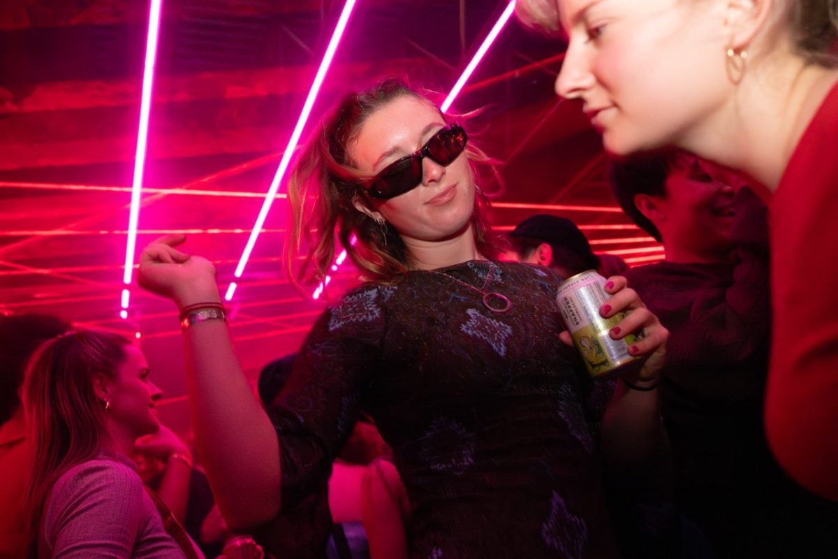 Holding her drink, an @CTION Party attendee dances to Yeah Yeah Yeahs’ “Heads Will Roll” on Thursday, March 5 at Harpo’s Bar & Grill in Columbia, Mo. Groups of partygoers formed circles, encouraging others to dance.