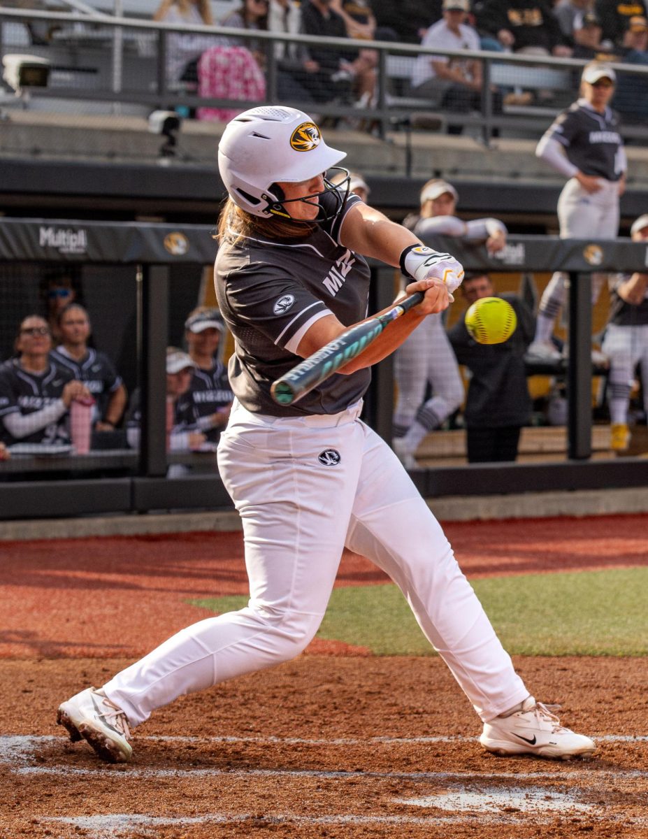 Twisting her body, junior Abby Hay prepares to hit the ball being pitched to her by Drake University in the Mizzou Invitational on Feb. 28 at Mizzou Softball Stadium in Columbia. During the game against Drake, which lasted five innings, Hay scored two runs for the Tigers.