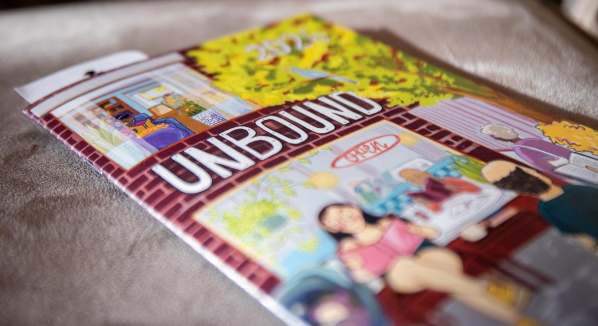 An Unbound Book Festival pamphlet sits on a chair while people walk around the first stop of the Lit Crawl on Thursday, April 17 at Orr Street Studios in Columbia, Mo.