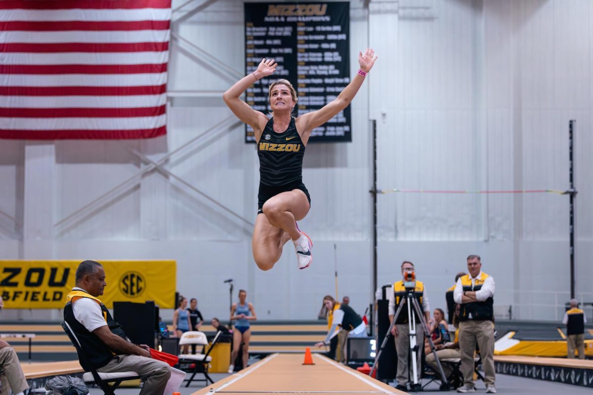 Pentathlon athlete Brianna Utecht reaches towards the ceiling and pushes forward, getting the maximum distance out of her jump on Saturday, Jan. 30 at Hearnes Center Fieldhouse in Columbia, Mo. Utecht placed first in the pentathlon scoring 4,017 points across all her events.