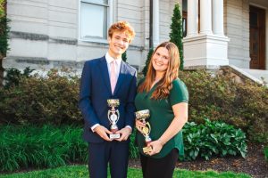 University of Missouri Speech and Debate members Lilly Nutter and Ben Montbriand hold trophies from the Pi Kappa Delta Biennial national tournament on Monday, May 11, outside Jesse Hall in Columbia, Mo. Nutter was the champion of dramatic interpretation at the tournament, with Montbriand taking runner-up.